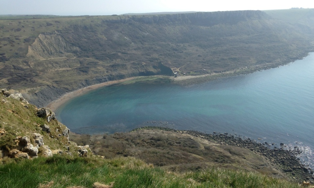 Chapmans Pool on the Jurassic coast. It is a large, blue lagoon carved into the hillside.