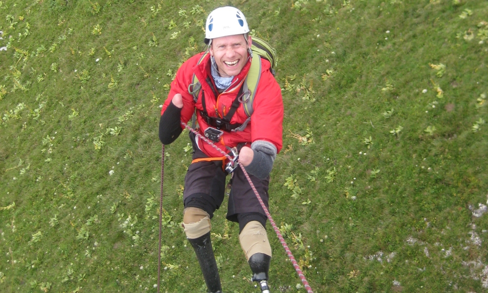 Disabled climber Jamie Andrews abseiling.