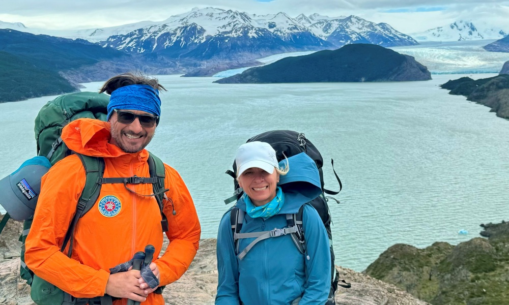 Gwen and Andy Bevan in front of a lake and glacier in Patagonia.