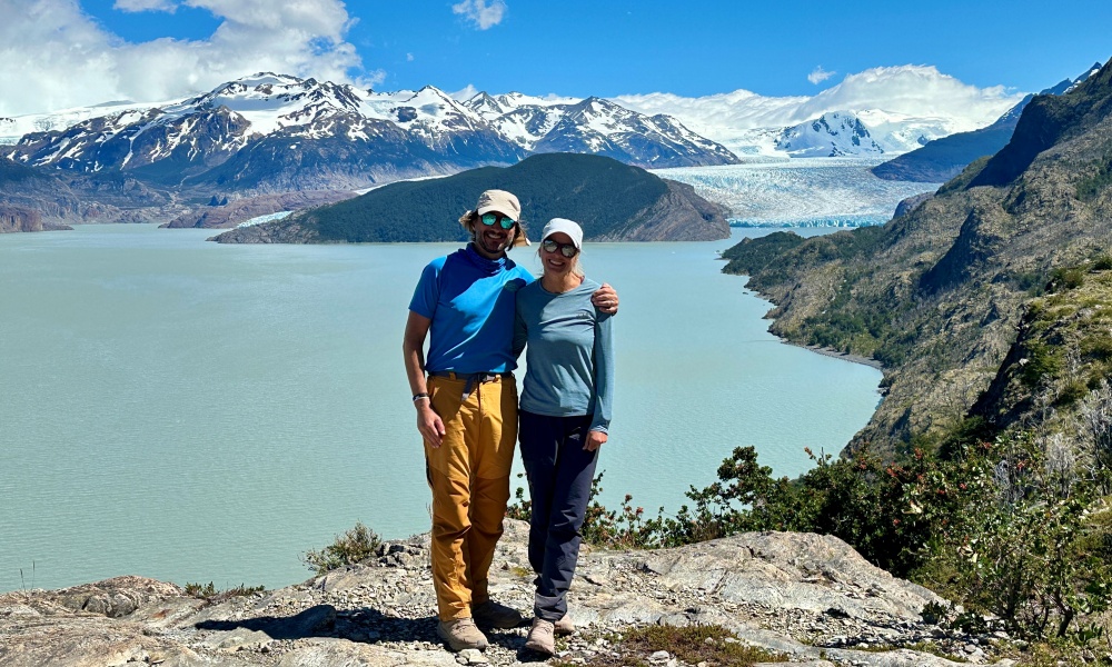 Gwen and Andy Bevan in front of a lake and glacier in Patagonia.