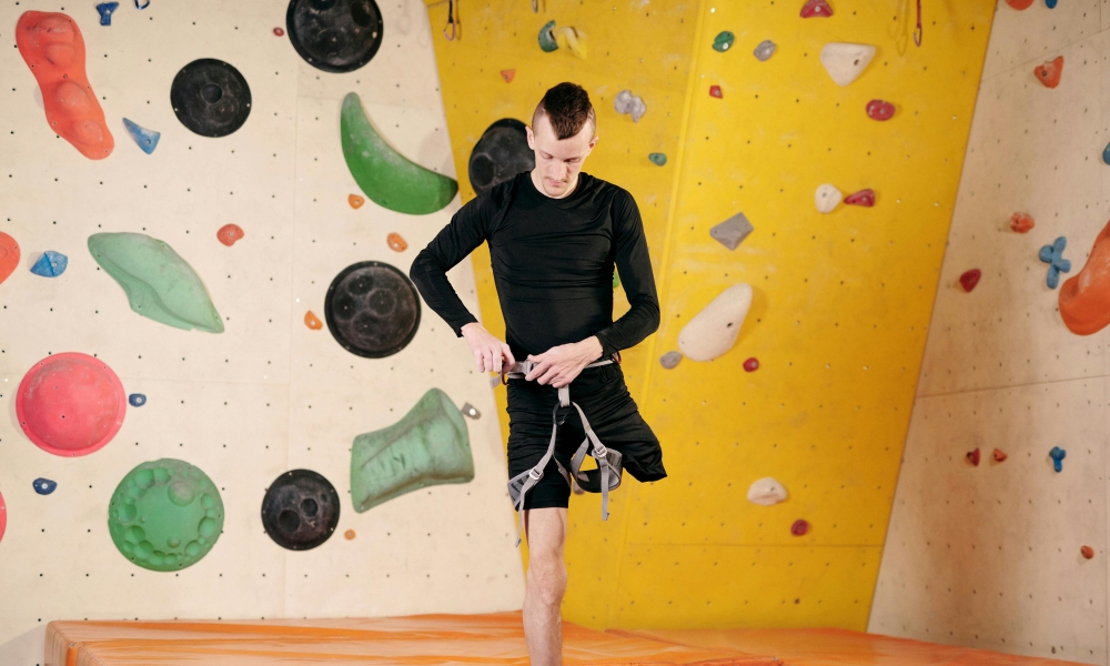 Disabled climber putting on a harness.